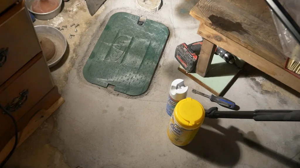 Finished green access cover over a backwater valve
