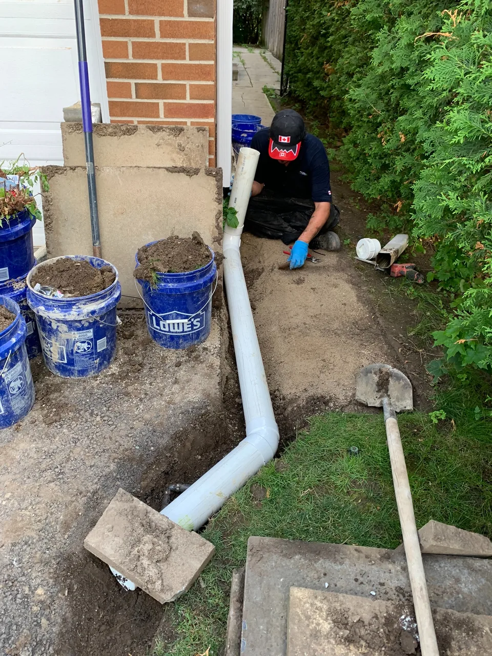 Downspout discharge pipe routed away from the foundation