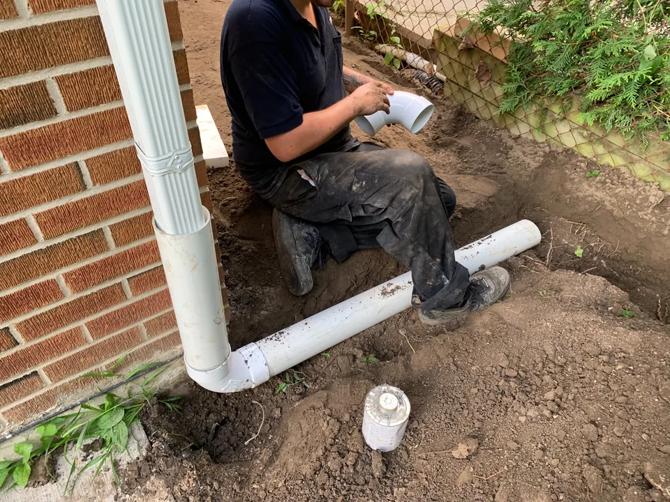 Flood Ready technician installing a buried downspout discharge pipe