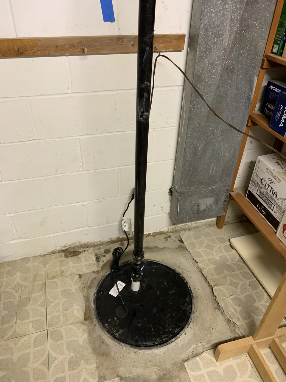 Completed sump pump system with sealed basin cover and discharge piping